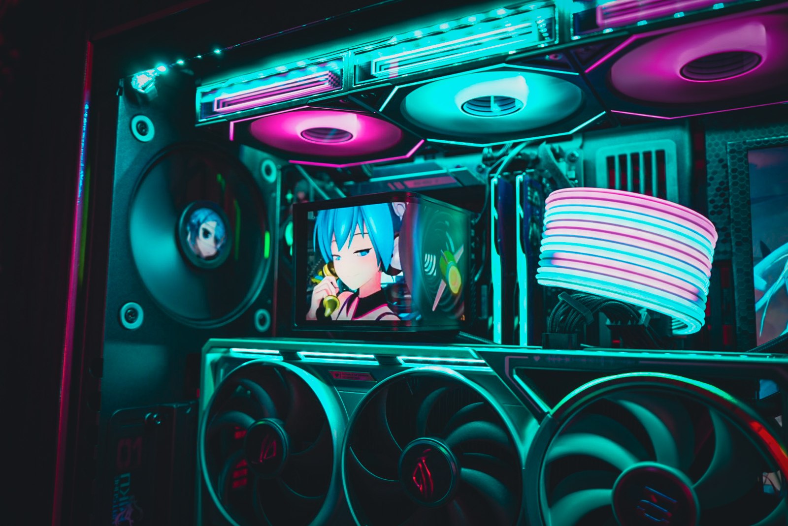 A SYNQ custom gaming PC with cyan and pink lighting